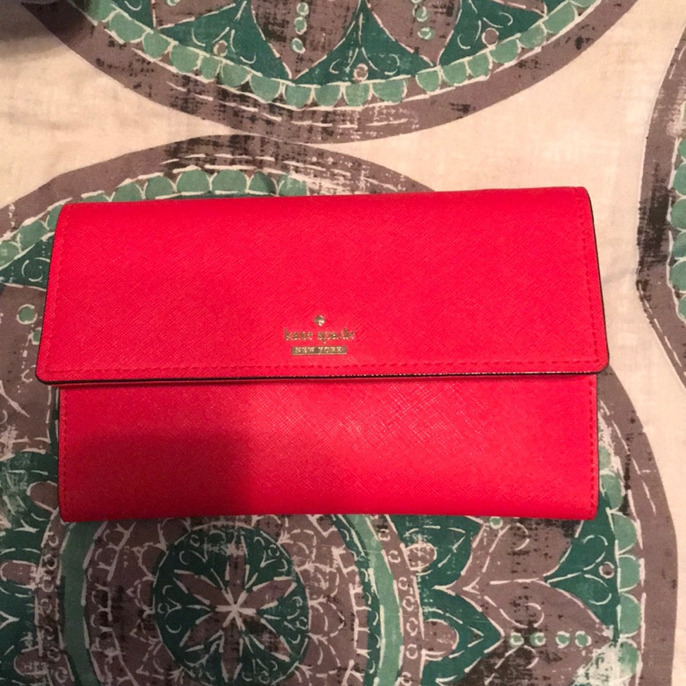 red kate spade wallet with a cross body strap